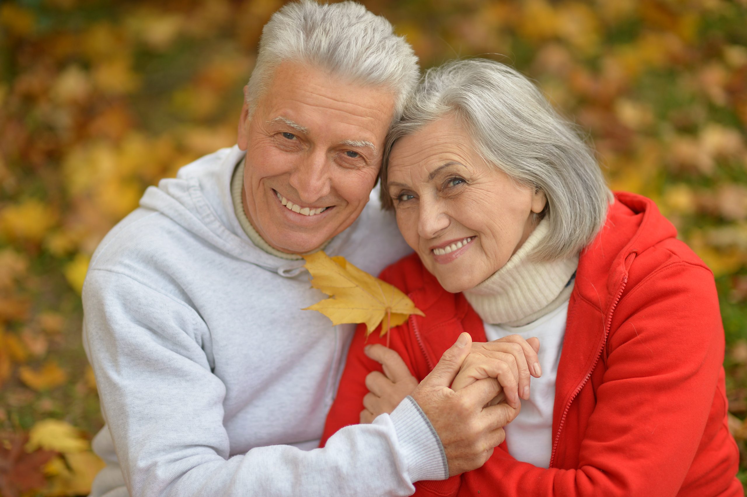 Happy senior couple relax in autumn park